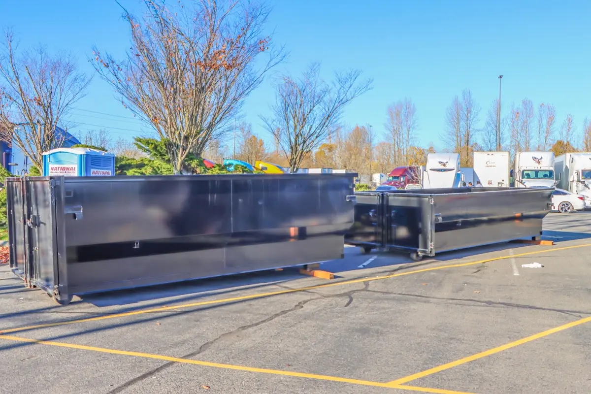 Professional dumpster rental service with roll-off container on residential driveway in Safford